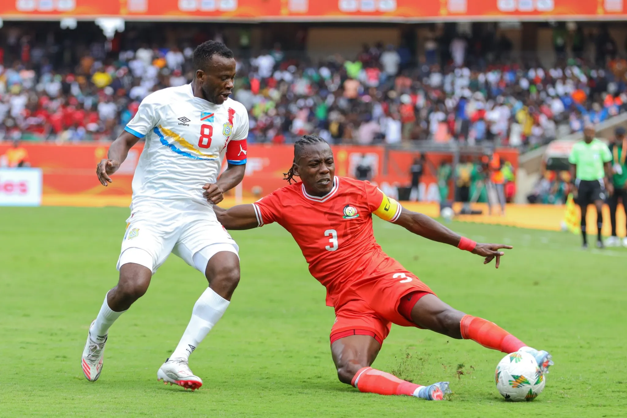 Kenya captain makes a sliding tackle against DR Congo during a football match.