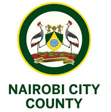 Official emblem of Nairobi City County featuring crowned cranes, a shield with lions, triangle, and water waves, and the Swahili motto ‘Shauri Kwa Uaminifu’.
